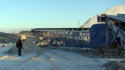 Worker near large outdoor conveyor Equipment